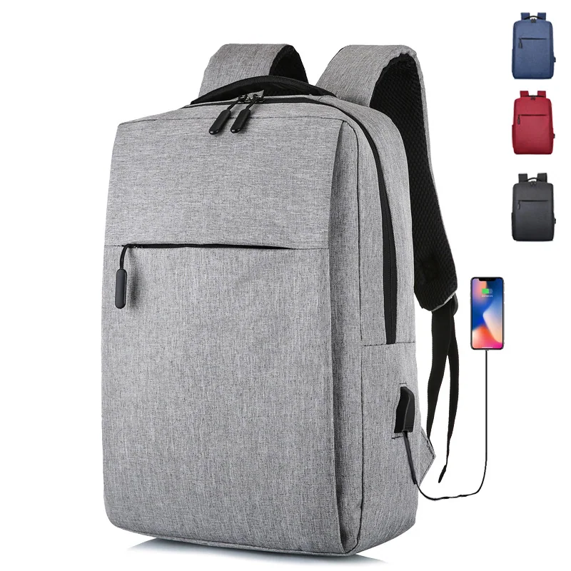 Gray laptop backpack with front pocket and charging cable detail